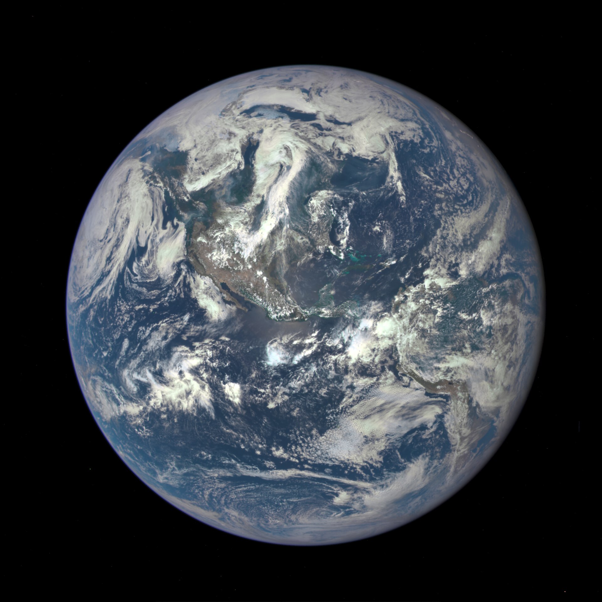 The full Earth seen from space against black, blue oceans and white cloud swirls fully lit, no Moon or other objects in frame.